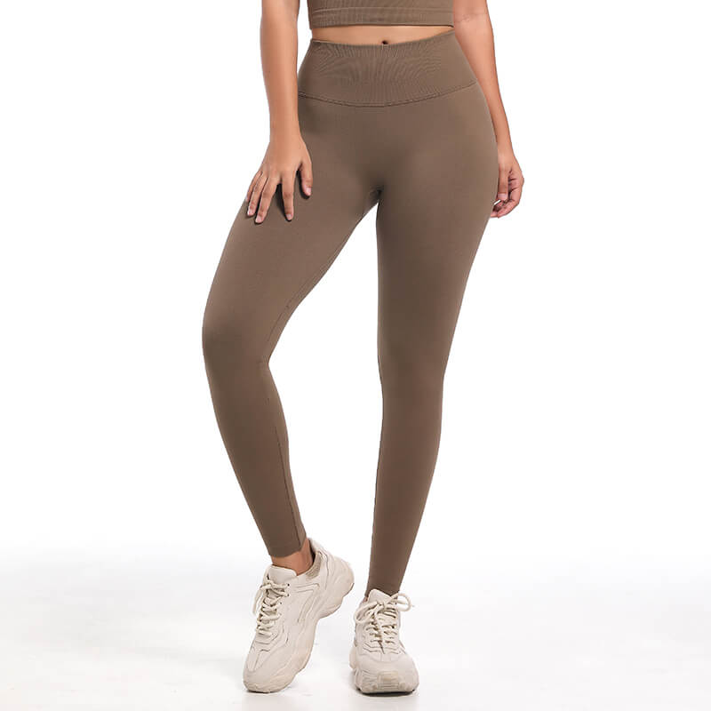 Front view of model's legs wearing brown seamless high waist leggings